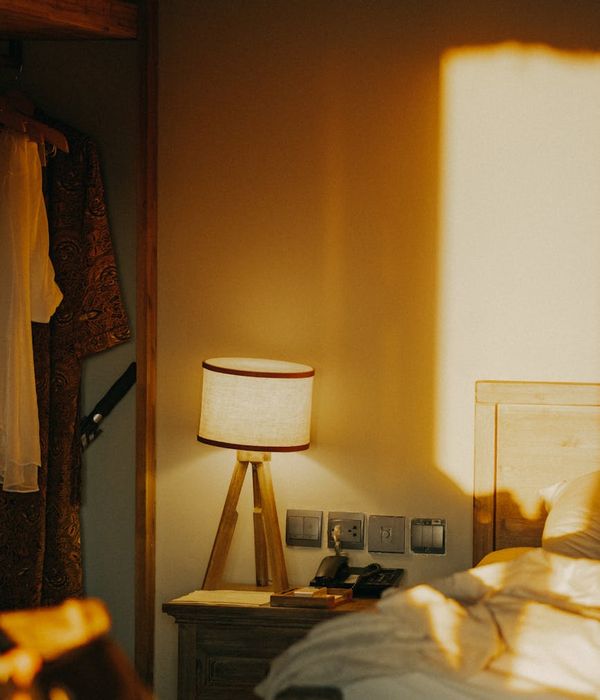 A calm yoga studio interior with minimalist design and warm golden lighting.